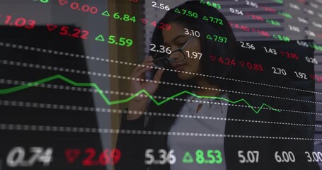 Businesswoman taking call on phone and scanning animated stock ticker while analyzing market data - Powered by Adobe