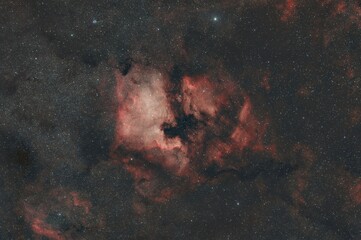 Vibrant nebula with pink, red, and yellow hues