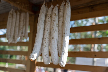 French dried sausages hanging and curing in wooden shed