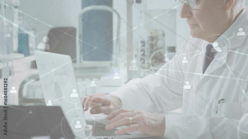 Poster senior scientist in lab typing on laptop, causing network-user icons and lines mapping data sharing