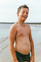 Smiling boy enjoying summer vacation on beach