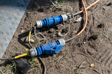 High voltage industrial electrical connectors lying on ground