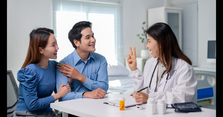 A doctor is talking to a man and a woman in a hospital room