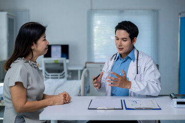 A doctor is talking to a woman in a hospital room