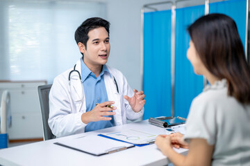 A doctor is talking to a woman in a hospital room