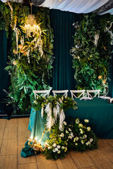 Luxurious restaurant. Luxurious interior, white tables, serving dishes and glasses for newlyweds....
