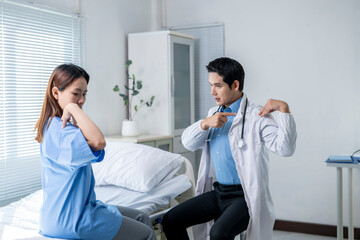 A man in a white coat is pointing at a woman in a blue shirt