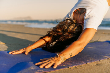 Focused Yoga Stretch on Beach at Sunrise