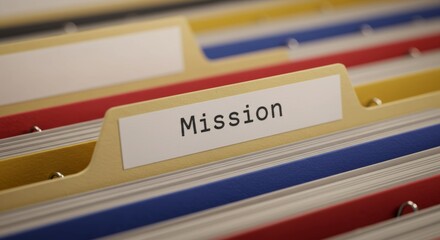 Focused depth image showing colorful file folder system with mission label