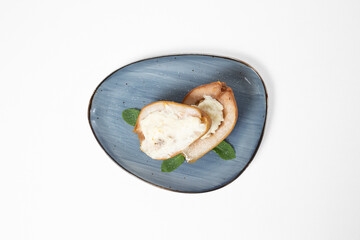 Baked pears with delicate sauce on a plate on a white background