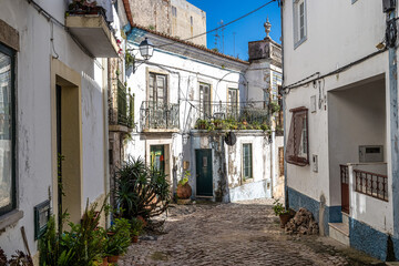 Beautiful narrow streets, white houses and facades of Alcacer do Sal in Portugal