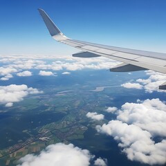 Obraz premium High-altitude view of land and clouds seen from an airplane.