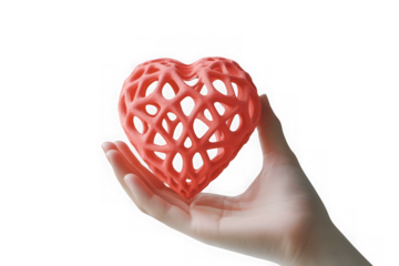 Close up of a delicate coral pink 3d printed hollow heart shape held gently in a person s open palm against a stark black background
