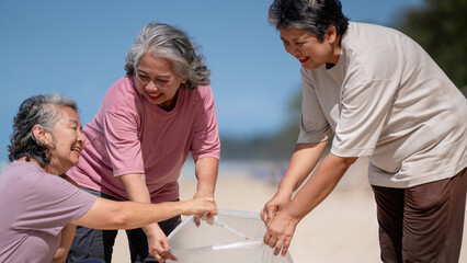 A group of older people are picking up trash on the beach to help keep nature clean and beautiful.