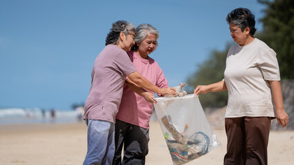 A group of older people are picking up trash on the beach to help keep nature clean and beautiful.