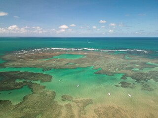 Aerial view of Pontal de Maraca&iacute;pe in Porto de Galinhas, Brazil, with crystal clear sea, natural pools, jangada boats and paradise beach in the northeast coast &ndash; drone photography