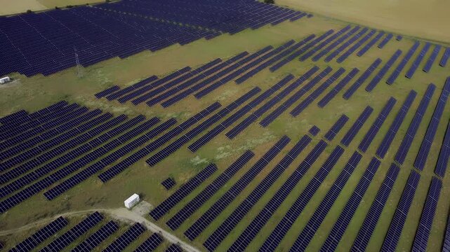 Solar Farm Aerial View Clean Renewable Energy - A vast field of photovoltaic solar panels generating clean energy. Concept of eco-friendly power production in Europe, promoting sustainable energy solu