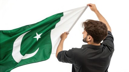 A young man joyfully raises the Pakistani flag celebrating independence and national pride isolated
