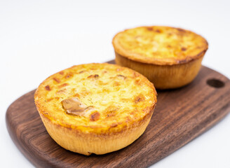 Smoked Salmon and Goat Cheese Quiche Tarts on Wood Board side view of Savory Brunch