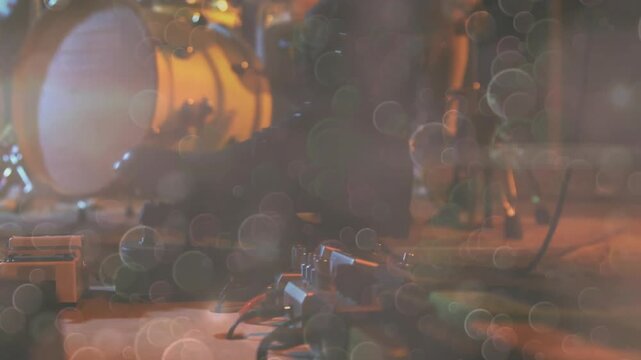 Stage lights shimmering casting drifting bokeh circles over audio cable cluster and splitter box