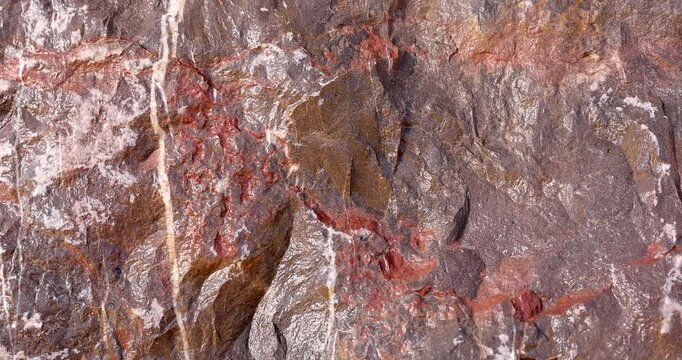 Closeup weathered rock texture push in revealing mineral surface and detail