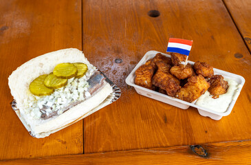 Traditional Dutch Fish Dishes, Herring Sandwich, known in The Netherlands as Broodje Haring, and Kibbeling Side by Side