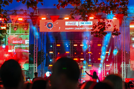Coca-Cola Happy Energy Tour. Light Show. Colorful lights, stage effects, Coca-Cola Happy Energy Tour evening concert performance. Concept of Coca-Cola experience, celebration, unforgettable atmosphere