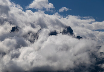Majestic mountain peaks emerge through a sea of clouds