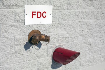 Wall with fire department water hydrant connection and exhaust pipe