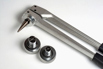 Detailed shot of a professional metal tool with additional parts on a white background.