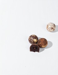 Indulgent gourmet chocolate truffles, one revealing rich ganache, perfect for luxury confectionery