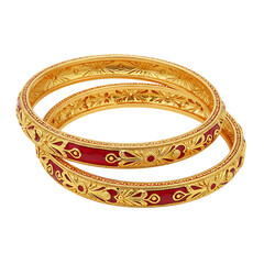 Two ornate gold bangles with red enamel details isolated on transparent background