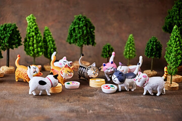 Charming cats run to try a treat in honor of the holiday - International Cat Day. Animal protection concept.