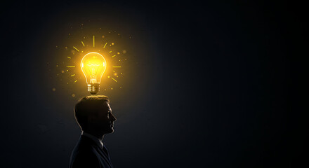 Businessman silhouette with a glowing lightbulb above his head symbolizing creativity, innovation, and a bright idea.