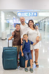 A happy wife with two sons meets her husband and father at the airport from a flight