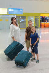 A happy wife with two sons meets her husband and father at the airport from a flight