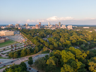 Various Sunset Drone Images of Downtown Raleigh NC Featuring the Skyline, Dix Park, and Central Prison.