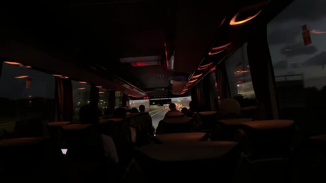 Large regular intercity bus with tourists. Tourist international transport. The interior of the bus, people passengers on a city tour. Transportation of employees to work.