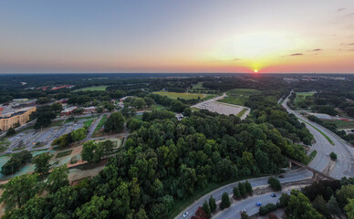 Various Sunset Drone Images of Downtown Raleigh NC Featuring the Skyline, Dix Park, and Central Prison.