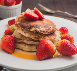 Stack of Pancakes with Strawberries and Syrup