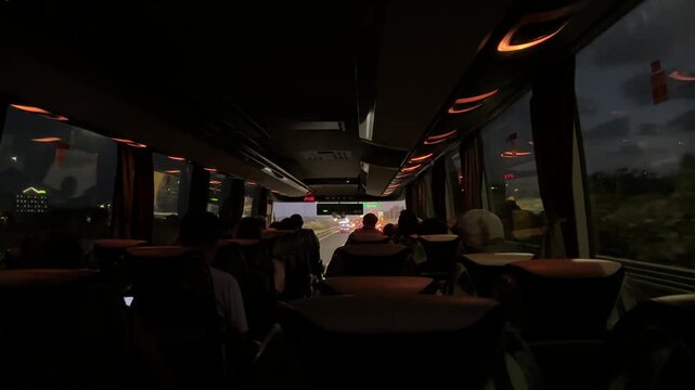 Large regular intercity bus with tourists. Tourist international transport. The interior of the bus, people passengers on a city tour. Transportation of employees to work.