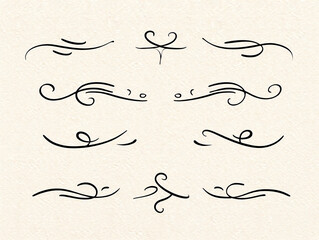Collection of black decorative ornamental swirls and lines on beige paper