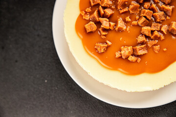 Cheesecake salted caramel sweet dessert fresh delicious gourmet food background on the table rustic food top view copy space