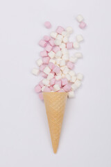 Cone with overflowing pink and white mini marshmallows.