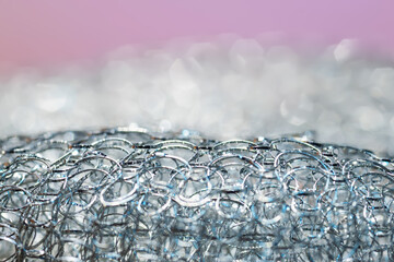 Metallic twisted wire close-up. Abstract texture. Colored lighting. Macro photography. Selective...