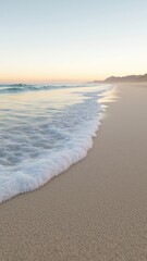 Fototapeta premium Gentle waves washing over a sandy beach as the sun rises painting the sky with soft pastel hues creating a serene and peaceful coastal atmosphere
