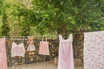 Different clothes drying on laundry line against garden background,clothes hanging laundry on...