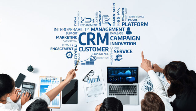 A dynamic business team collaborates on customer relationship management strategies, analyzing data visualization tools to drive innovation and improve performance in a corporate setting. Amity