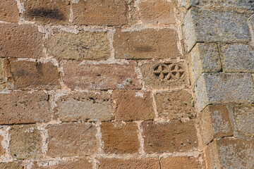 Stone wall detail with carved cross on San Andres church in Matabuena Palencia
