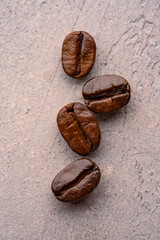 Close up coffee beans on stone background
